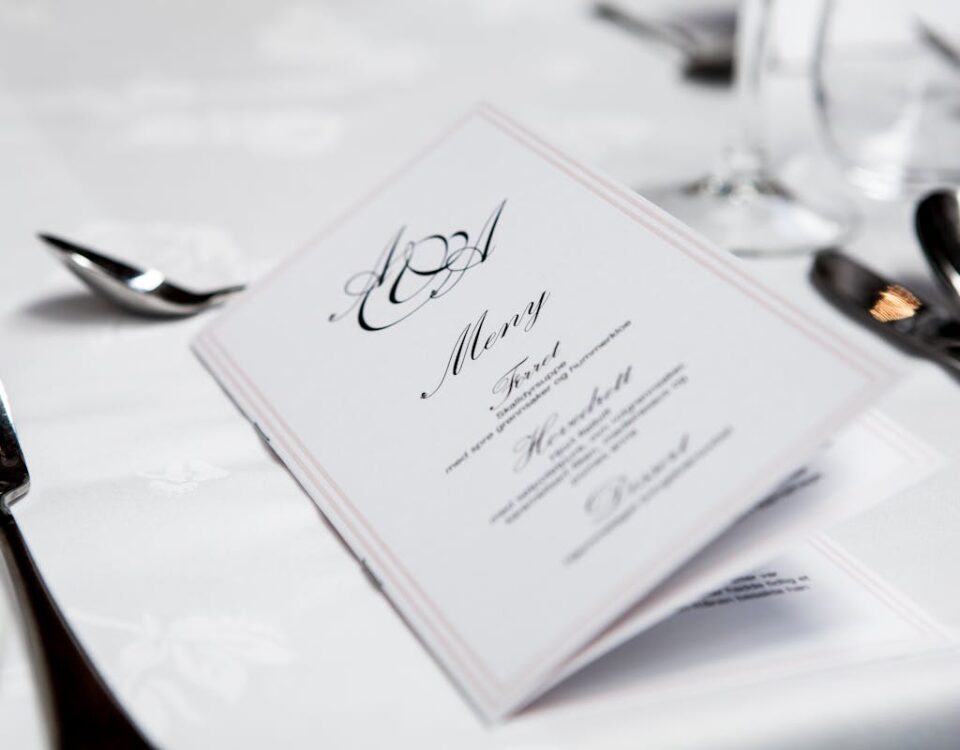 Inteligência artificial no planejamento de cardápios Close-up of a refined dining table with menu and silverware, showcasing elegance in a formal restaurant setting.
