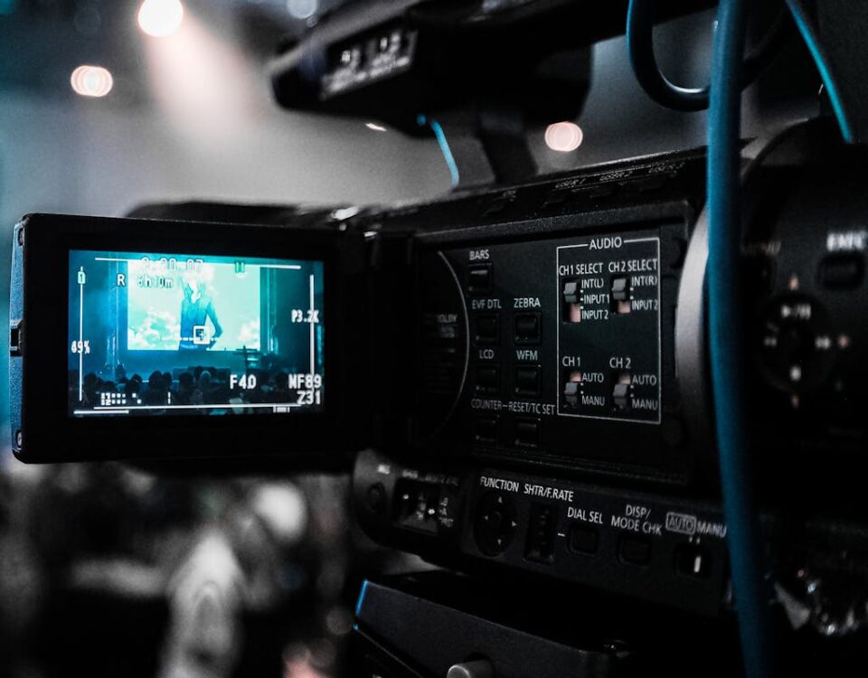 IA está mudando a forma de assistir filmes? HD video camera capturing a live event; focus on screen and controls.