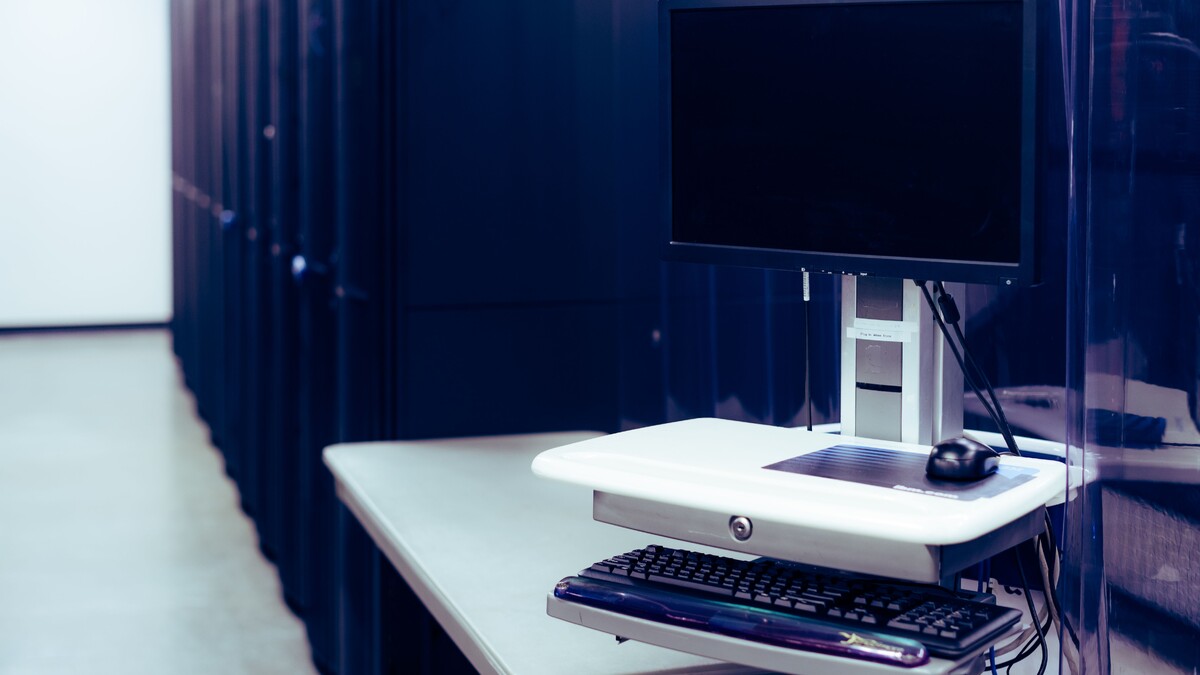 Computador instalado próximo a racks de servidores